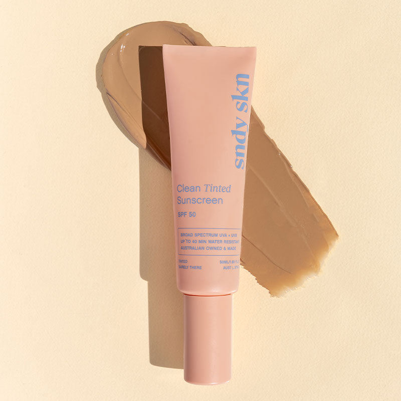 Pink tube of Sody Skin Clean Tinted Sunscreen on a beige background